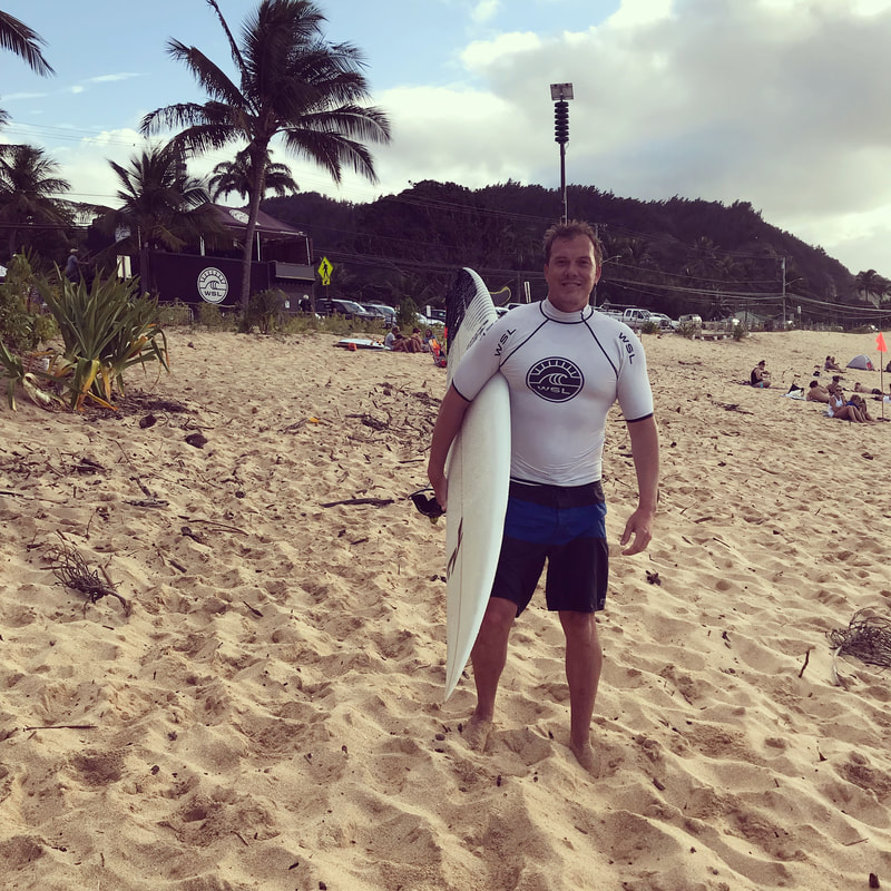 Bjorn on the beach with surfboard in Hawaii