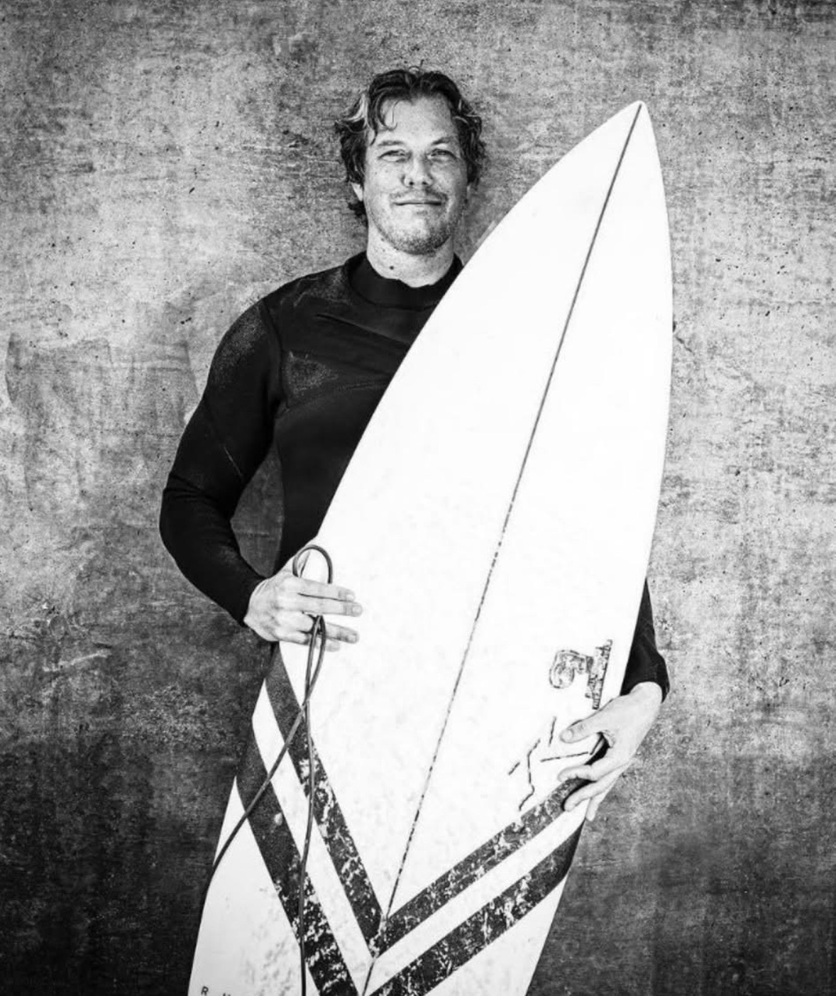 Bjorn holding a surfboard